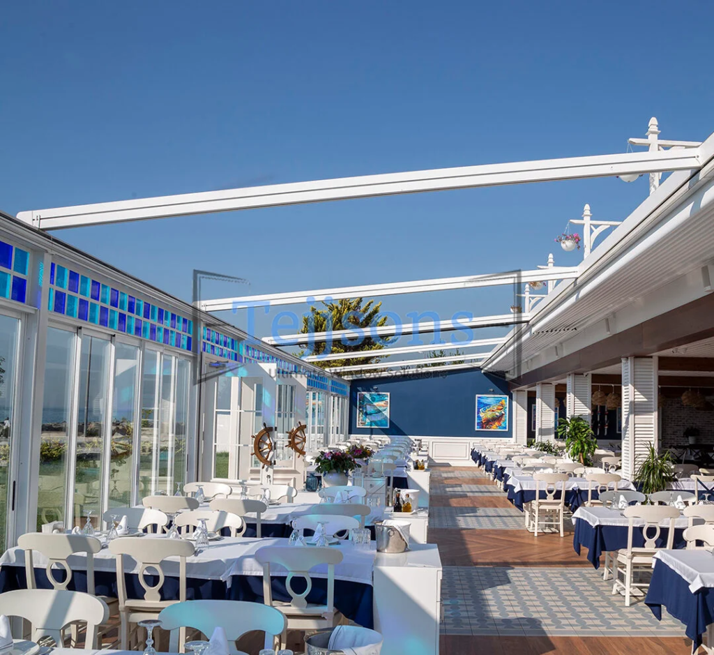 How An Aluminium Pergola Can Transform Your Outdoor Space 2 Coastal dining setup shaded by a motorized pergola