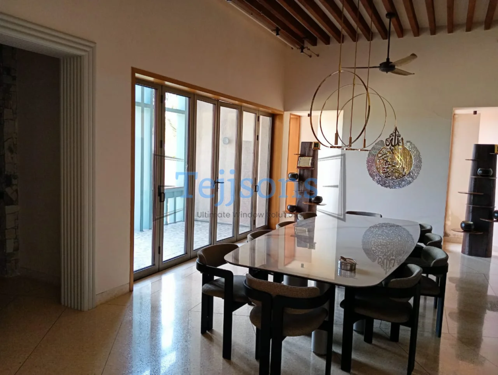 How Architects Use Slide and Fold Doors to Design Column-Free Openings 4 Interior slide and fold doors connecting dining space to balcony