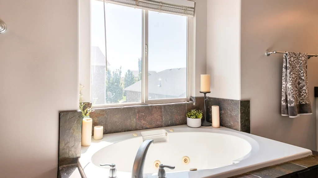 White casement windows installed in a modern bathroom area