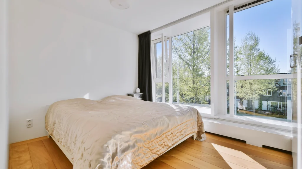 Large casement windows in a bright modern bedroom